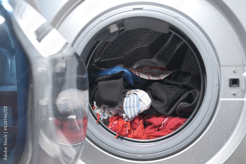 close up of cloths in a washing machine. close up of cloths in a washing machine.