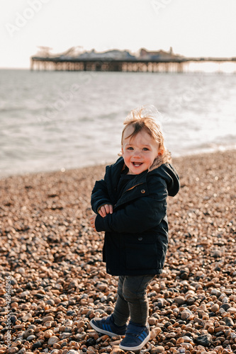little child on the beach laughing 