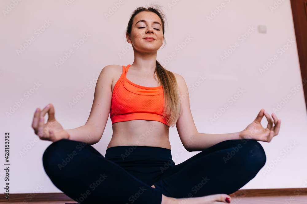 Woman wearing sportswear working out practicing yoga, relaxing i