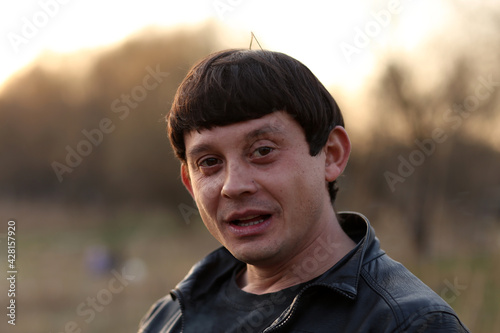 Portrait of a brunette man in the park