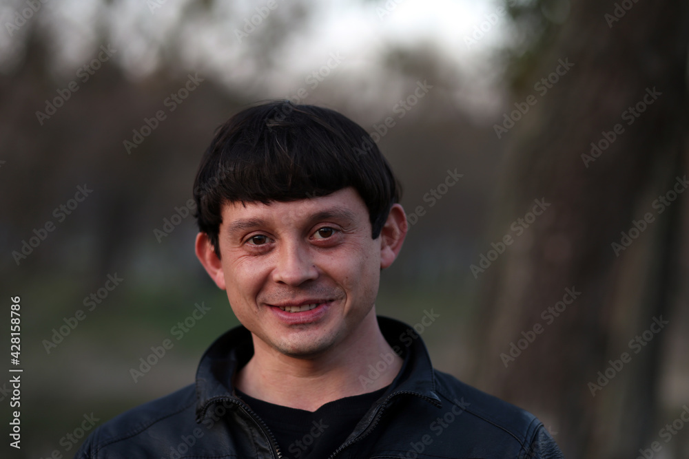 Portrait of a brunette man in the park Portrait of a brunette man in the park