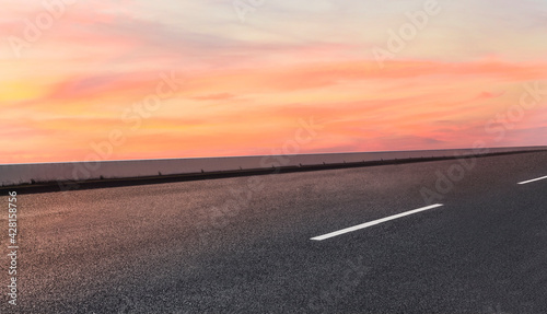 Empty asphalt street road on highway with beautiful sky in background.