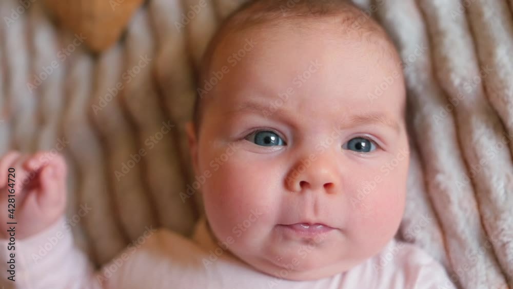 Portrait of a two month old baby, close up. Emotions of a small child. Warm colors. Portrait of a two month old baby, close up. Emotions of a small child. Warm colors.