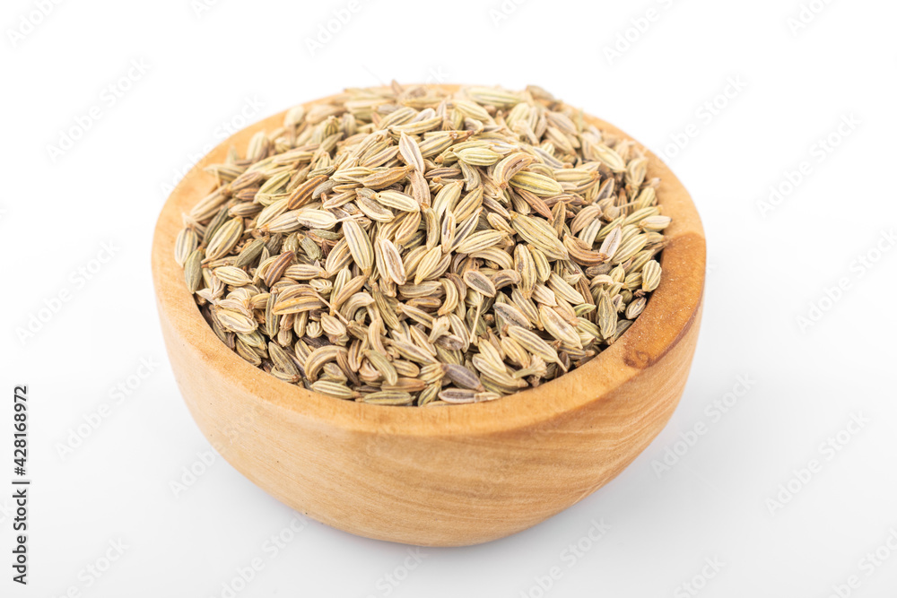 fennel seed. dry fennel seed in wooden bowl on white background. fennel