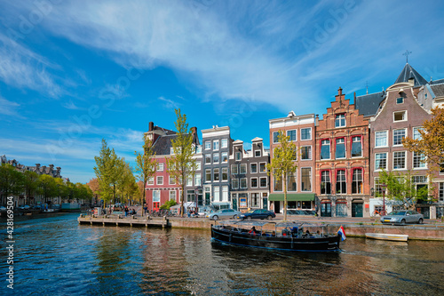 Amsterdam view - canal with boad, bridge and old houses © Dmitry Rukhlenko