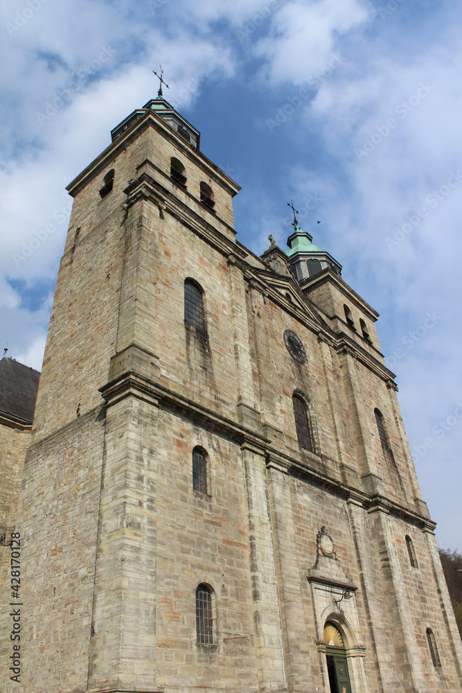 Exterior view of the 18th century St. Peter's Cathedral in Malmedy, in the province of Liege, Belgium. With copy space above.