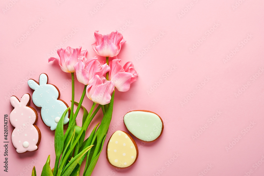 Pink tulips with easter gingerbread eggs located in a row on pink background. Floral pattern. Mock up and banner. Space for text. Pink tulips with easter gingerbread eggs located in a row on pink background. Floral pattern. Mock up and banner. Space for text.