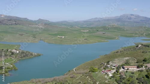 Lake Prizzi in the heart of the Sicani mountains in Sicily. Lush vegetation with wheat crops. Rurality in Sicily. Green in Sicily in spring. Relax by the lake. Migratory birds.