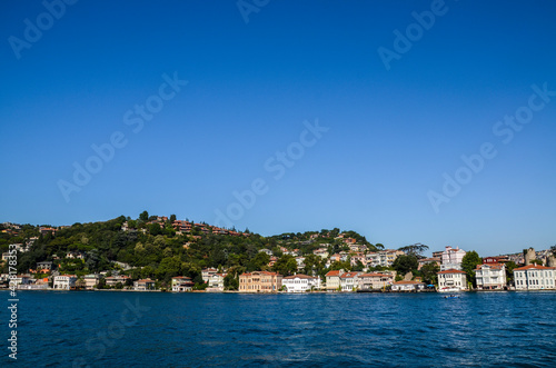 Beautiful view of the residential area, hillside waterfront colorful houses and a park from the Bosphorus Strait in Istanbul, Turkey.