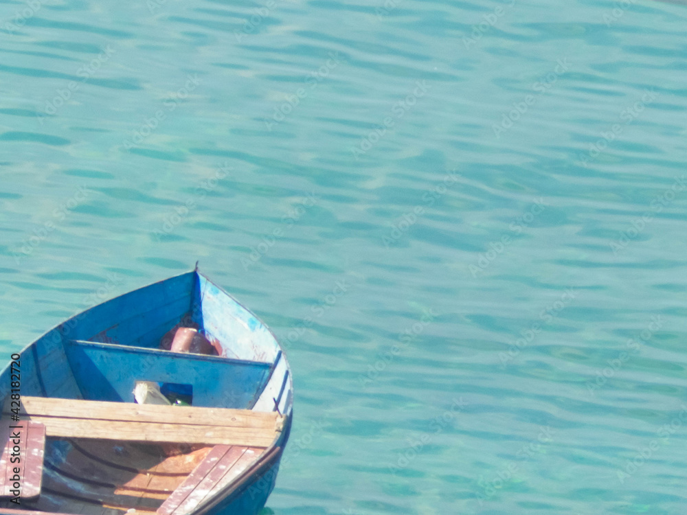 Small fishing boat on water of Ochrid Lake.