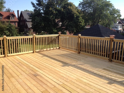 Fototapet Construction of large wood deck on flat roof garage