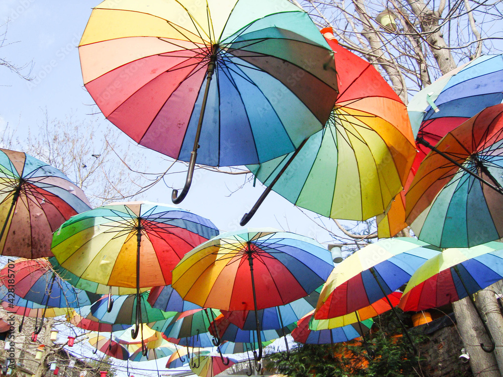 festive street decoration. multicolored umbrellas on a blue sky background
