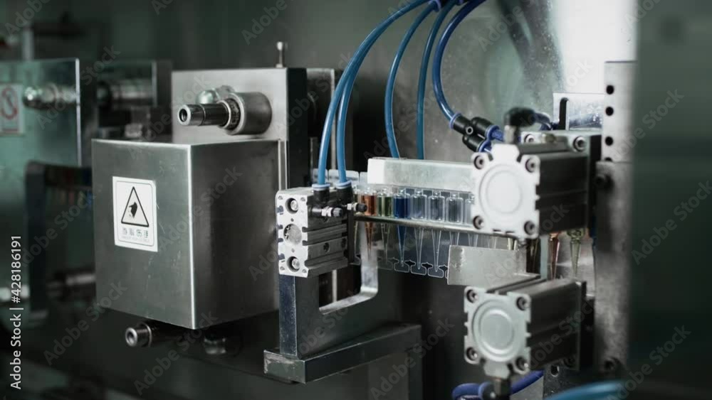 Automatic machine for pouring medicine into ampoules or test tubes. Automatic machine for pouring medicine into ampoules or test tubes.