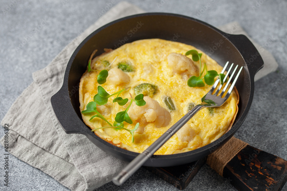 Broccoli cauliflower egg omelette in a plate on the table. Diet nutrition Broccoli cauliflower egg omelette in a plate on the table. Diet nutrition