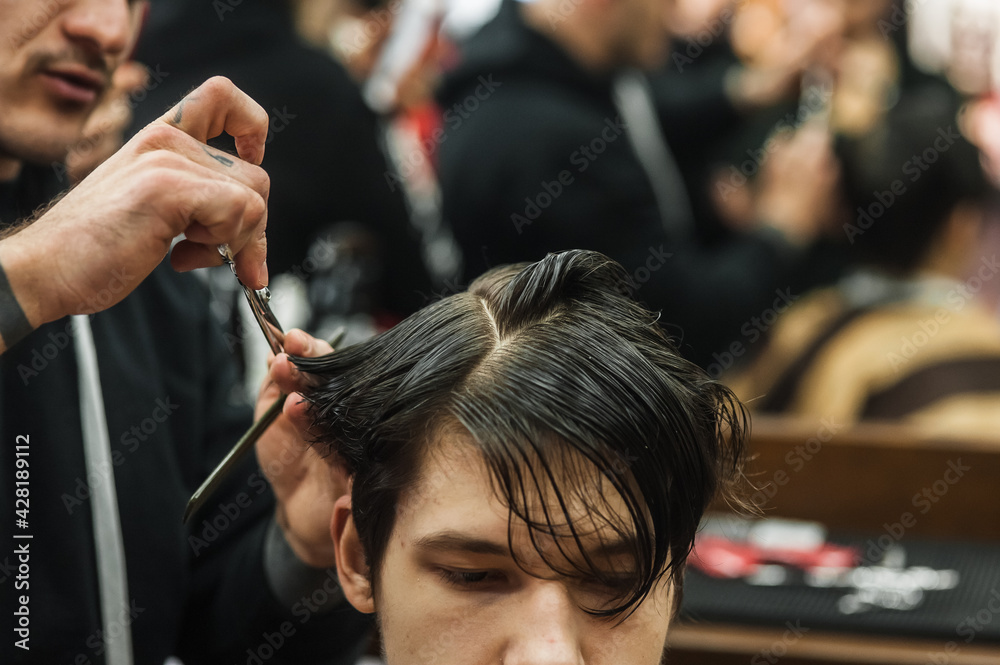 Hipster client man visiting in barber shop shaving hair. Modern guy having his hair cut in barbershop. Hipster client man visiting in barber shop shaving hair. Modern guy having his hair cut in barbershop.