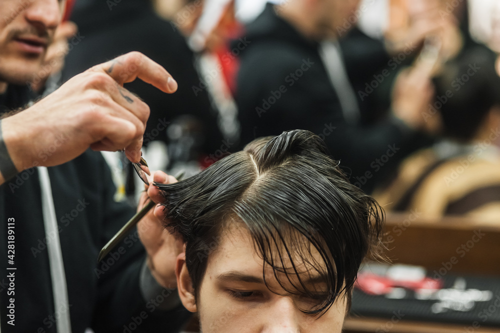Hipster client man visiting in barber shop shaving hair. Modern guy having his hair cut in barbershop. Hipster client man visiting in barber shop shaving hair. Modern guy having his hair cut in barbershop.
