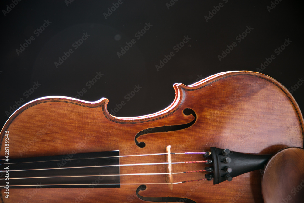 Close up of a violin isolated on a black background