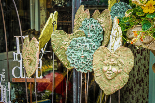 фотографія Unusual handmade clay fairy and Greenman garden stakes on display in the springt