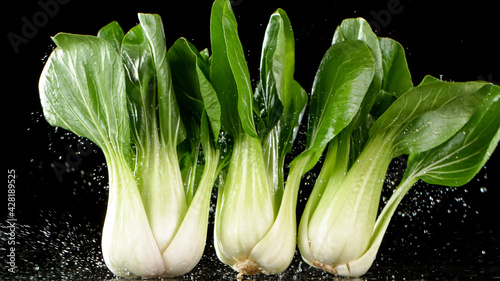 Fresh pak choi falling on b...