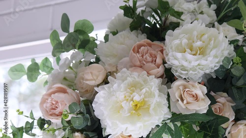 artificial flowers of white and peach color close-up.