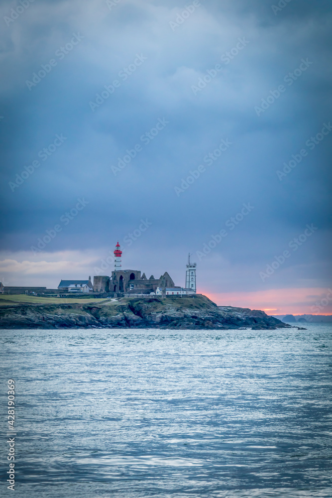 Background with sea and lighthouse on the coast of Brittany, Finistere, France