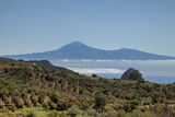 The landscape in the mountains leads to the ocean overlooking the neighbouring island and the volcano. A trip inland to the island of Gomera, Canary Islands. Travel on the paths of Garajonay National 