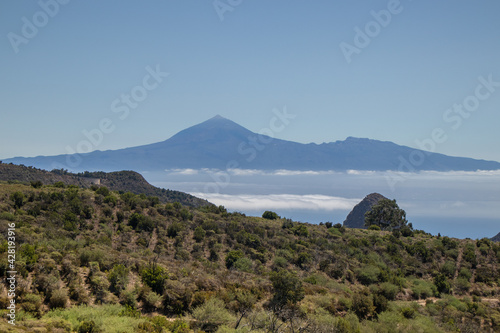 The landscape in the mountains leads to the ocean overlooking the neighbouring island and the volcano. A trip inland to the island of Gomera, Canary Islands. Travel on the paths of Garajonay National  © Boyana