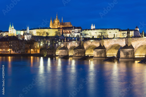 Scenic view on Prague Castle and the St. Vitus cathedral and historical center of Prague, buildings and landmarks of old town at sunrise or dusk, Prague, Czech Republic. Beautiful and romantic evening