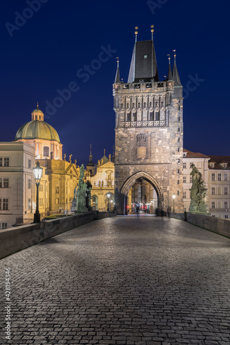 Scenic view on Vltava river, Charles bridge and historical center of Prague, buildings and landmarks of old town at sunrise or dusk, Prague, Czech Republic. Beautiful gothic buildings. © Michal