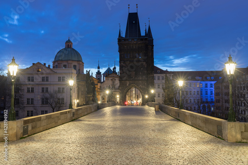 Scenic view on Vltava river, Charles bridge and historical center of Prague, buildings and landmarks of old town at sunrise or dusk, Prague, Czech Republic. Beautiful gothic buildings.