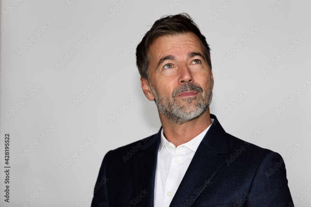 Serious Businessman looking up. He is concerned about achieving his goals. He is anxious. Lost in thought. Serious Businessman looking up. He is concerned about achieving his goals. He is anxious. Lost in thought.