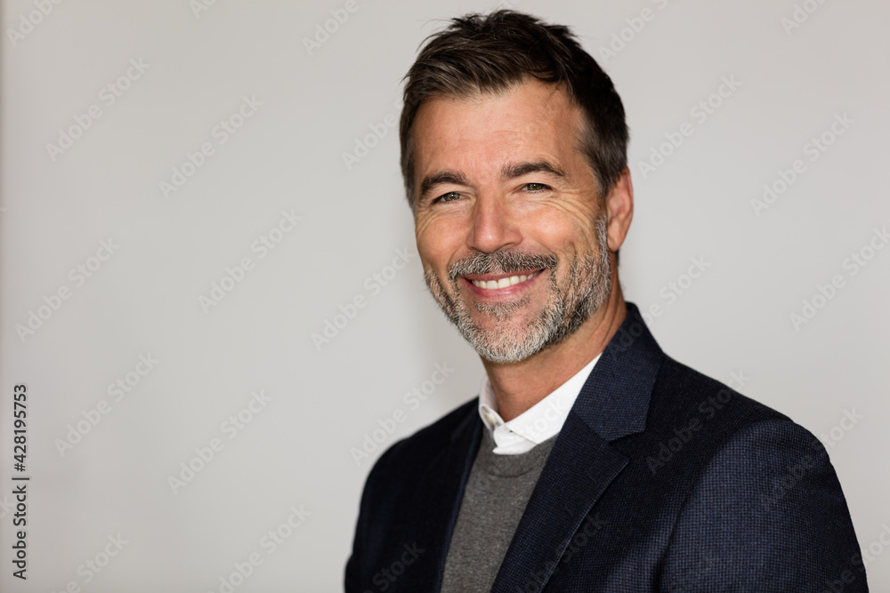 Close Up Of A Mature Man Smiling At The Camera. He is a CEO. Good looking businessman. Isolated on white. Close Up Of A Mature Man Smiling At The Camera. He is a CEO. Good looking businessman. Isolated on white.