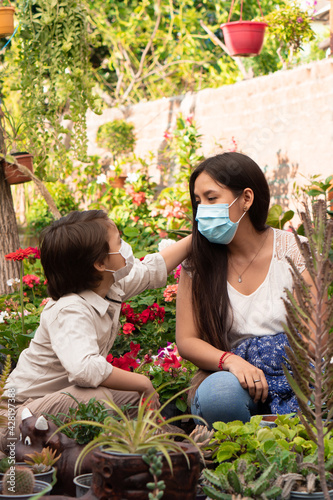 Single mother and her son. Day at the Greenhouse. Hispanic family.