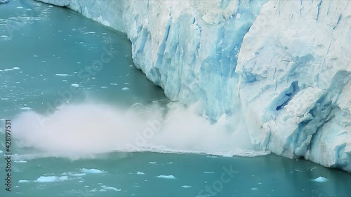 Los Glaciares National Park, Santa Cruz Province, Patagonia, Argentina. Natural beauty of towering glacier surrounded by glacial lake. A large mass of ice falls into the water. High quality 4k footage