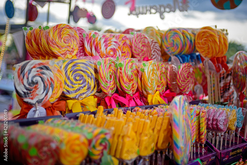 Multicolored sweet candies and lollipops at the holiday market