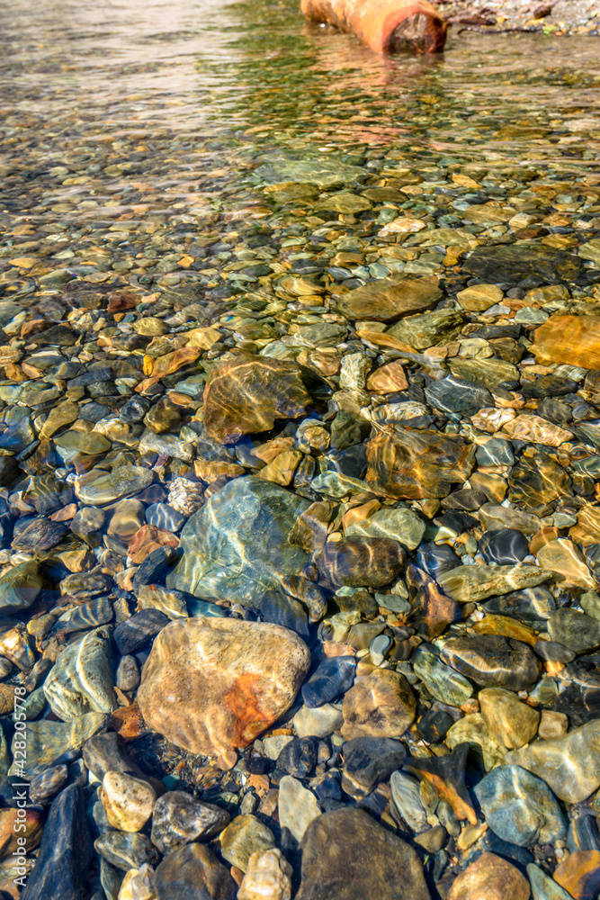 Pebbles under water background. Magnificent Seton Lake in Canada.