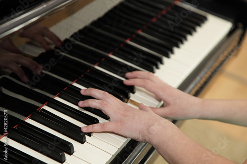 European piano girl white hands playing the old classical Piano close up, musical scale learning for music playing