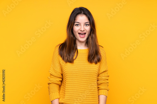 Young caucasian woman isolated on yellow background with surprise facial expression