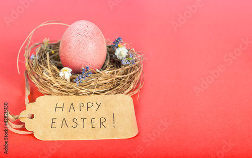 Colorful background with Easter eggs on red background. Happy Easter concept. Can be used as poster, background, holiday card. Flat lay, top view, copy space. Studio Photo