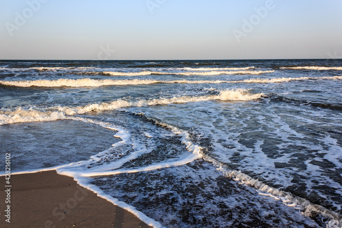 Intersecting waves on a sandy seashore