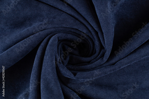 curtain fabric canvas dark blue, rolled into a spiral