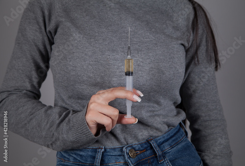 Wallpaper Mural Female drug addict hand syringe. Gray background. Torontodigital.ca