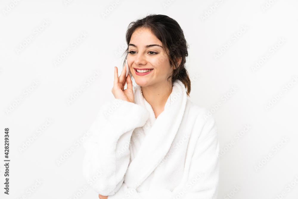 Young caucasian woman isolated on white background with cotton pad for removing makeup from her face Young caucasian woman isolated on white background with cotton pad for removing makeup from her face