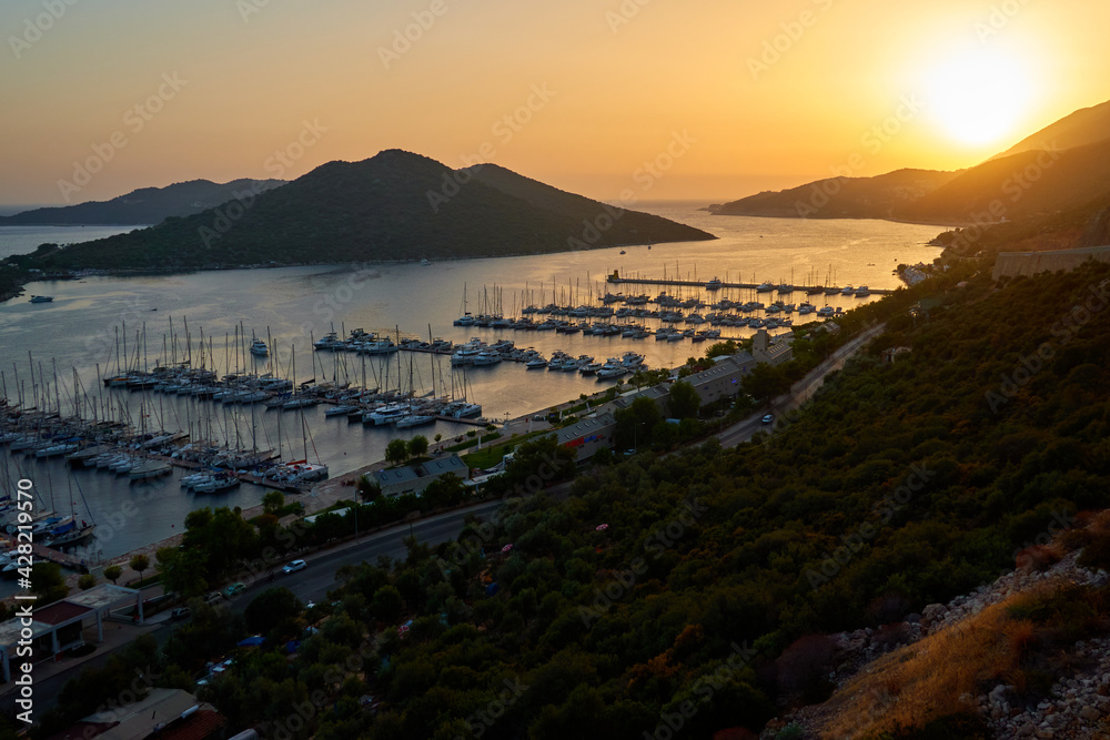 Amazing view of the small sea bay with boats and ships at the sunset