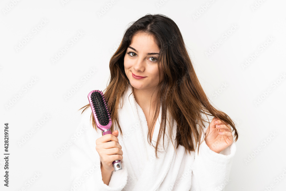 Young caucasian woman isolated on white background with hair comb Young caucasian woman isolated on white background with hair comb