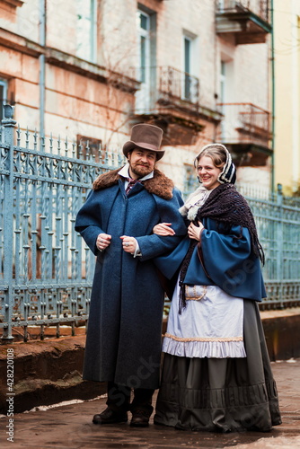 A man in a nineteenth century suit and a woman in a historical dress.