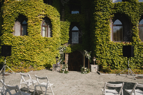 Coziness and style. Modern event design. Lounge zone and european traditional wedding ceremony decoration outdoors in the restaurant before the reception.