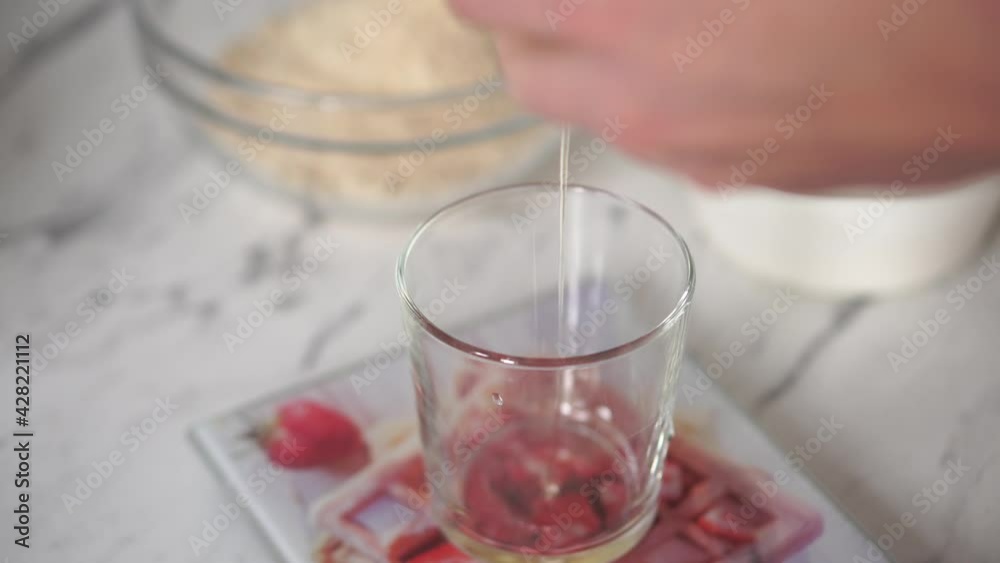 A woman separates egg yolks and whites for culinary and baking purposes A woman separates egg yolks and whites for culinary and baking purposes