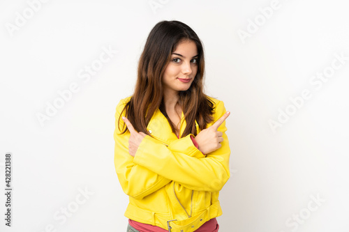 Young caucasian woman isolated on white background pointing to the laterals having doubts