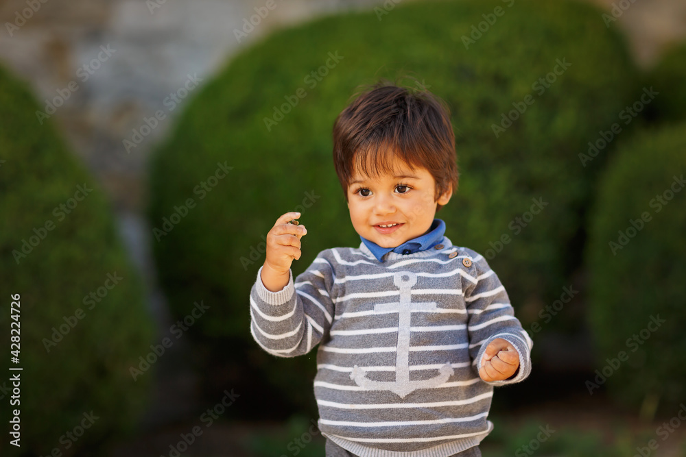 Portrait of a little eastern handsome baby boy playing outdoor in the park Portrait of a little eastern handsome baby boy playing outdoor in the park